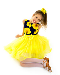 Little girl is sitting on the floor.