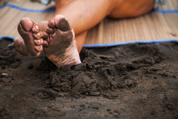 Legs against the background of sand.