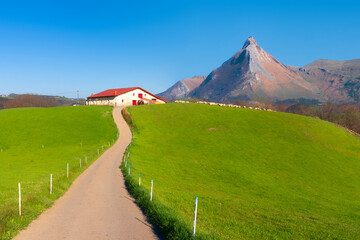 Rural landscape of farm in Goierri in Gipuzkoa against Txindoki mountain
