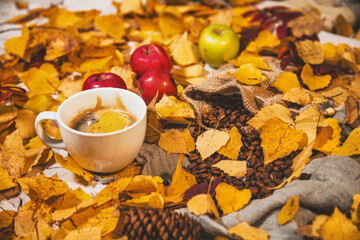 Autumn background. A cup of coffee on the autumn table.