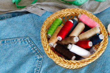 Basket full of colorful .spools of thread