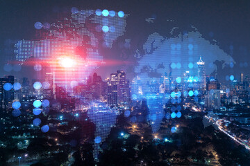 Hologram of Earth planet map on night panoramic cityscape of Bangkok, Asia. The concept of international companies. Multi Exposure.
