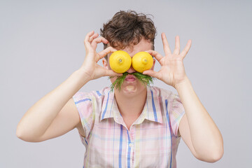 Pretty woman with healthy food, fruits and vegetables in a plate, isolated on gray