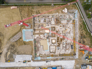 Aerial view of construction site in Switzerland with large crane.