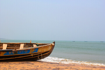 Naklejka na ściany i meble Wooden Fishing boat in a beach