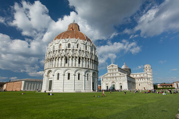 A view of the Baptistry with Pisa Cathedral and its medieval belltower, commonly know as The...