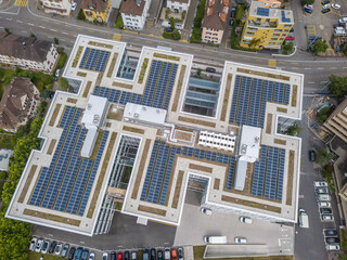 Aerial view of roof with solar cells for photovoltaic power generation. Concept of green energy for...