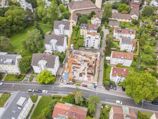 Aerial view of construction site in Switzerland with large crane.