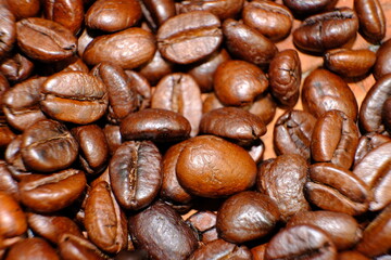 Blurred coffee beans on wood table and macro coffee beans background