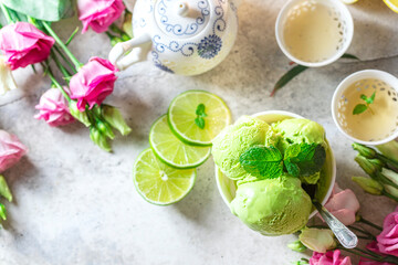 Green tea ice cream with lemon on a gray stone background.