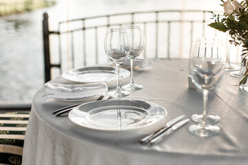 Table set at restaurant on light background for a wedding, romantic dinner or celebration