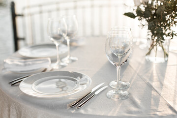 Table set at restaurant on light background for a wedding, romantic dinner or celebration