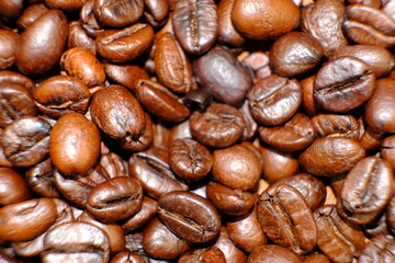 Blurred coffee beans on wood table and macro coffee beans background