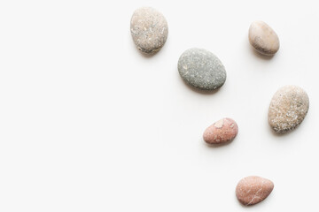 Fototapeta na wymiar sea ​​stones on a white background, round stones, background of stones