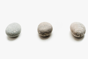 Fototapeta na wymiar sea ​​stones on a white background, round stones, background of stones