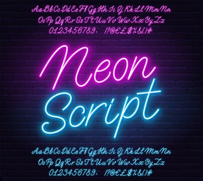 Neon pink and blue script alphabet font. Glowing letters, numbers and special characters on brick background.