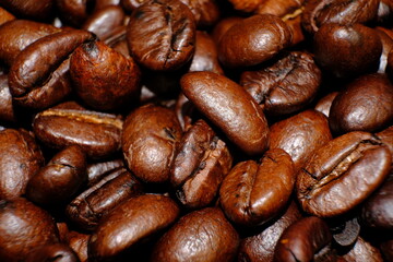 Blurred coffee beans on wood table and macro coffee beans background