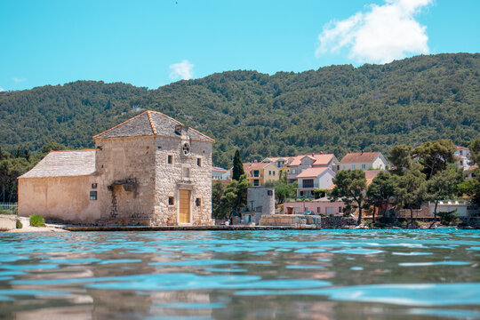 Small picturesque house of Saint Jerolim, stone greek style building standing on the waterfront of Starigrad,Hvar. Seen from the sea