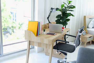 The office table looks clean and tidy in the background of the modern room.