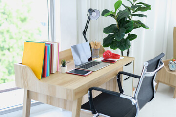 The office table looks clean and tidy in the background of the modern room.