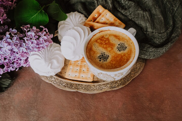 Morning breakfast. Spring flowers, platter with coffee cup and sweets.