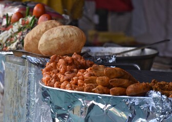 Indian street food stall with pakode and chole bhature