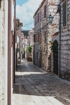 Fototapeta Narrow old streets in the town of Starigrad on the island Hvar. Old greek style stone houses and a narrow paved footroad going through them