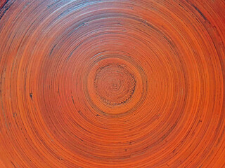 Woodwork painted in orange, texture of wooden circles, amber tint from sunlight