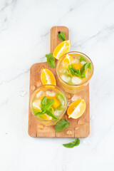 Fototapeta premium chilled drink with lemon and mint on a white background.