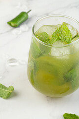 green drink with ice and mint close-up.