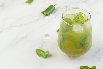 green drink with ice and mint and place for text.