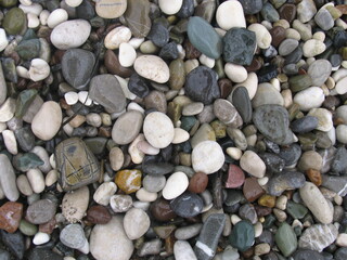 Naklejka na ściany i meble Texture of sea pebbles on the seashore