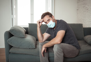 Lonely man suffering from depression at home during coronavirus lockdown and social distancing