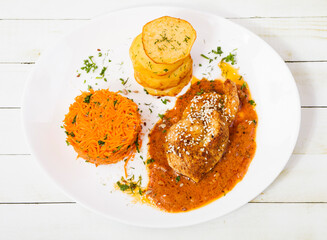 Fried lemon chicken with fried potatos and carrot salad from the top