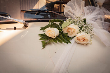 Malcesine, Lake Garda, Italy, August 2019, a bouquet of wedding flowers on a Fiat 500 bonnet