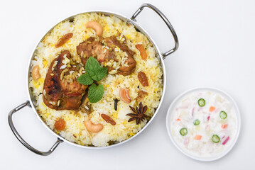 Top view of Bombay biryani, Traditional spicy indian food, Iftar meal, Chicken rice Ramadan dinner on white background.