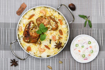 Top view of Bombay biryani, Traditional spicy indian food, Iftar meal, Chicken rice Ramadan dinner on white background.
