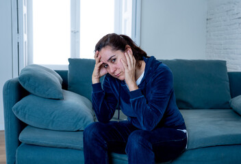 Young sad woman suffering from depression feeling lonely and hopeless isolated at home