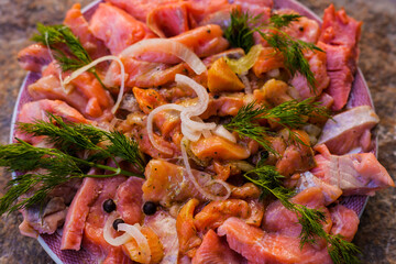 Pieces of red fish in marinade.