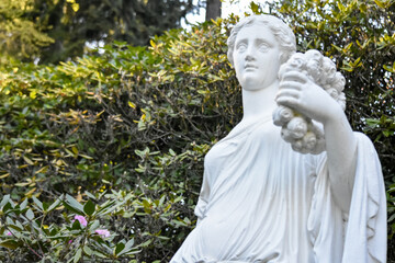 white statue of woman in the park, woman statue in the garden