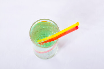 Fototapeta na wymiar Colorful straws in glass of green lemonade