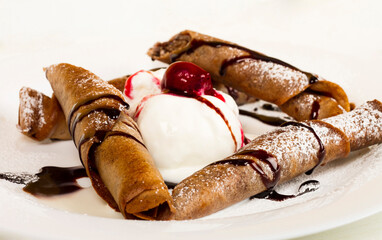 Chocolate crepes with ice cream close up