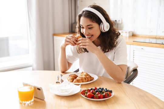 Photo Of Woman Watching Movie On Mobile Phone While Having Breakfast