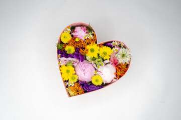 Beautiful colorful flower arrangement in a heart shaped box. 