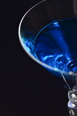 Half of a glass with a blue cocktail. View from above