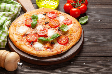 Tasty homemade pizza with tomatoes and basil