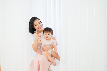 Mom and her daughter child girl are playing, smiling and hugging. Family holiday and togetherness.