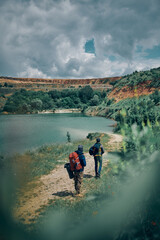 Two men with backpacks searching place for camping.
