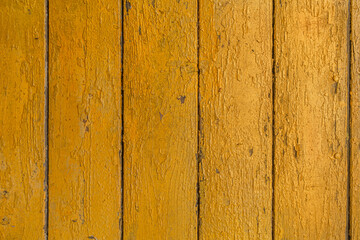 abstract background of old painted yellow wooden surface close up