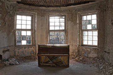 Beauty of decay - old abandoned piano in the leftovers of the former sanatorium in Oranienburg, Germany